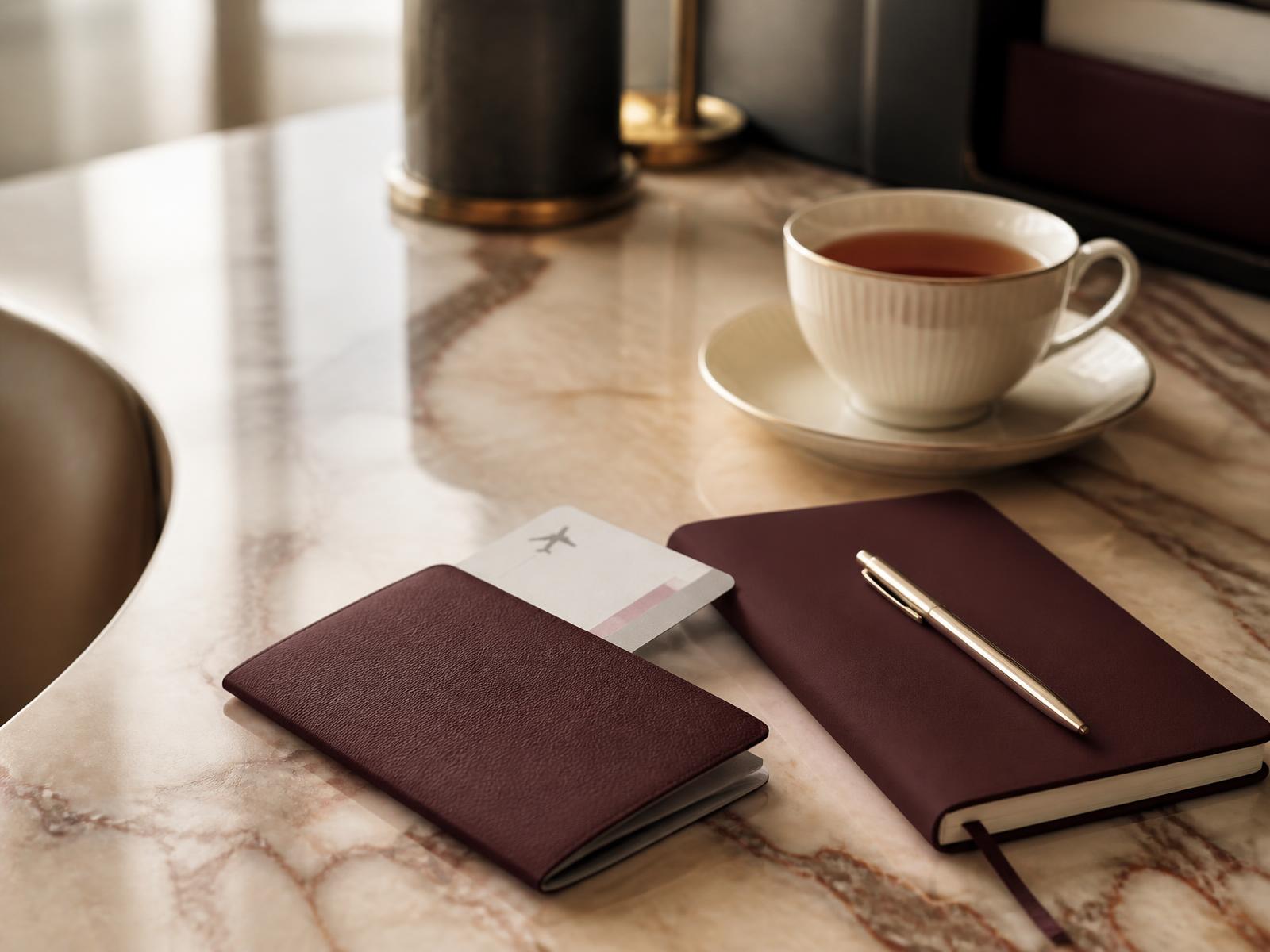 Passport, boarding pass and notebook prepared for a visa consultation